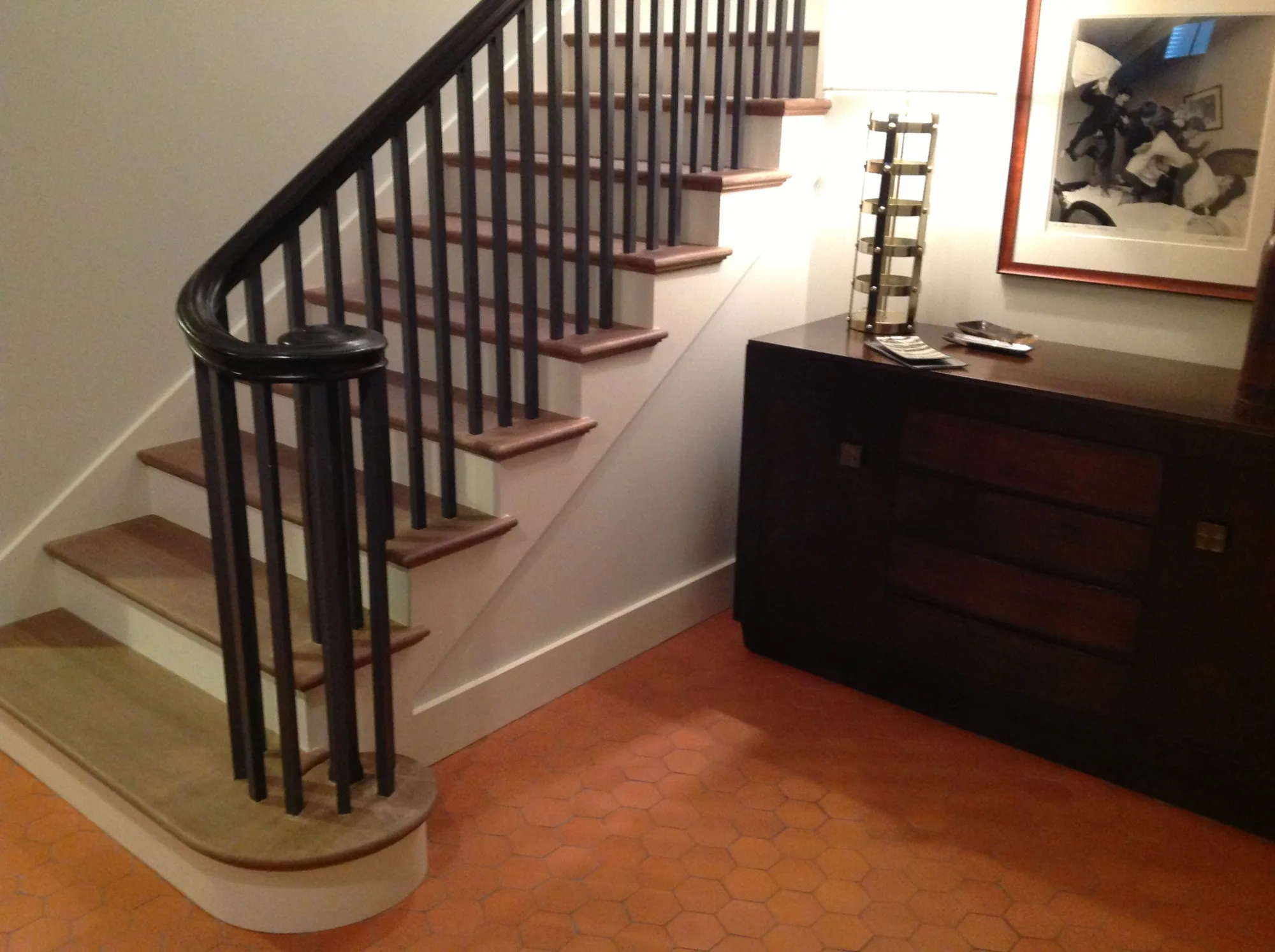 Lincoln Park entrance with a dark curved handrail and warm wood floor.