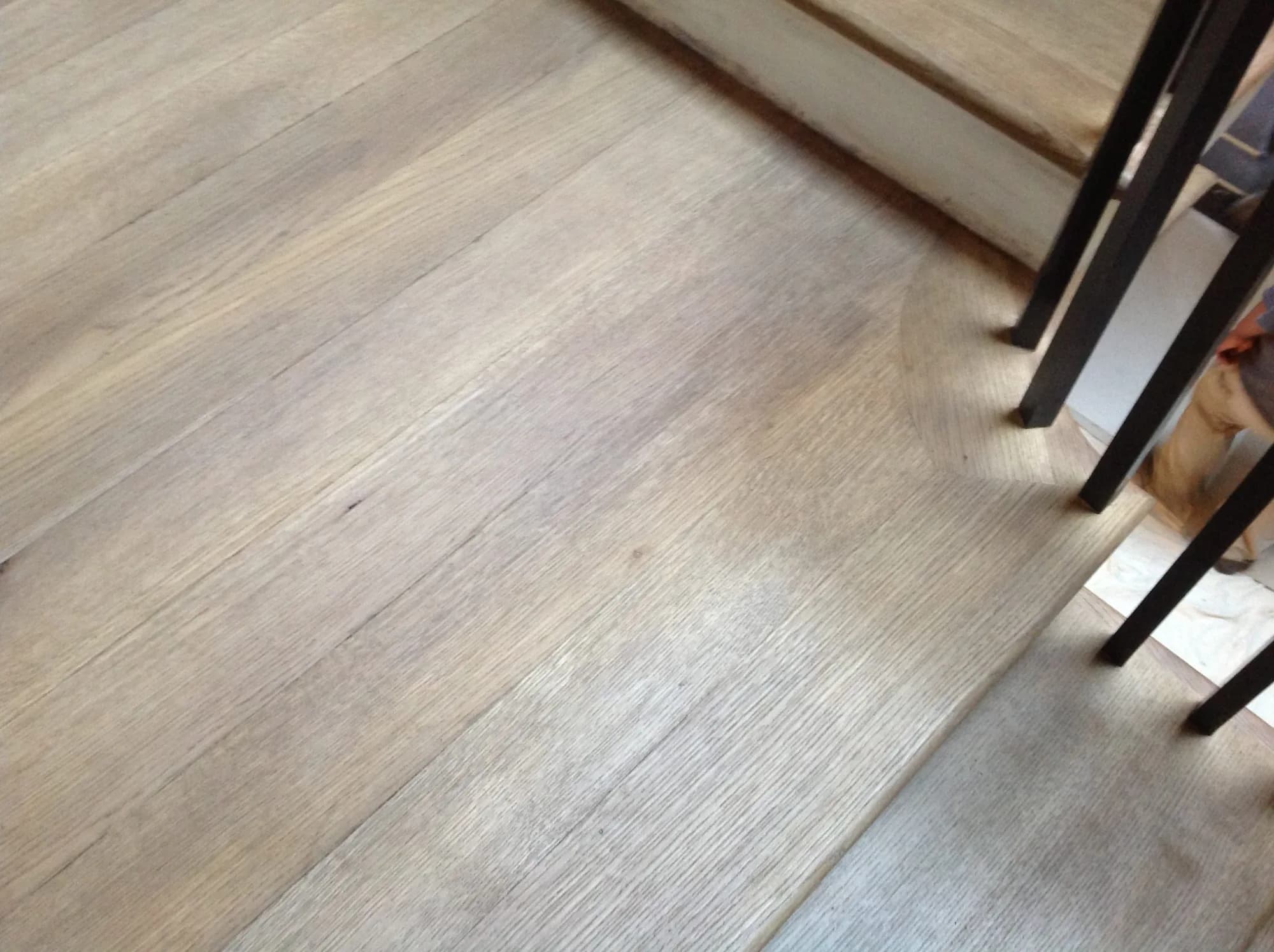 Pale grained wood flooring at the Lincoln Park stair landing.